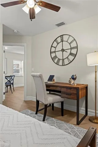 Office space featuring ceiling fan and light hardwood / wood-style flooring