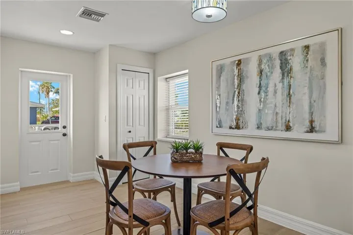 Dining space with plenty of natural light and light hardwood / wood-style floors
