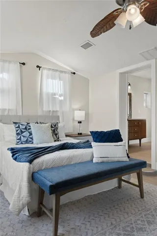 Bedroom with ceiling fan and vaulted ceiling