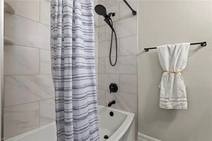 Bathroom with shower / tub combo with curtain