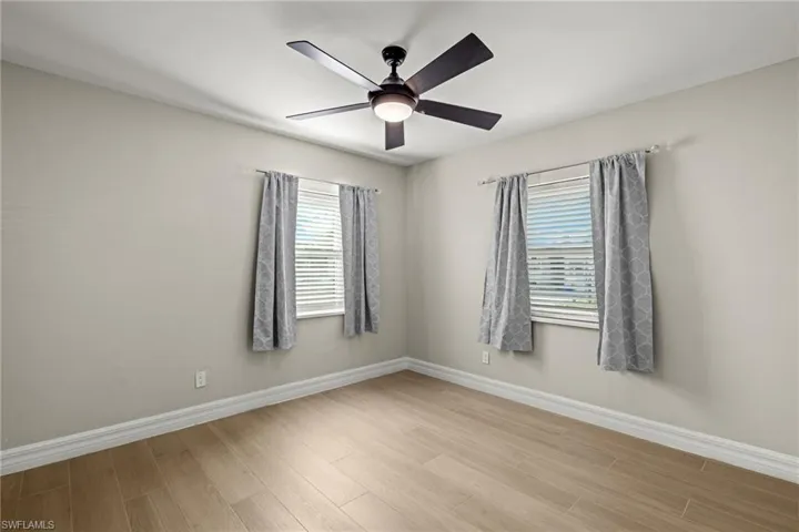 Spare room featuring light hardwood / wood-style floors and ceiling fan