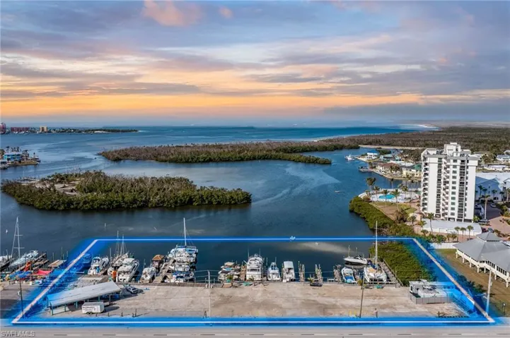 Aerial view at dusk featuring a water view