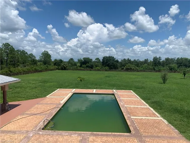 View of swimming pool with a lawn
