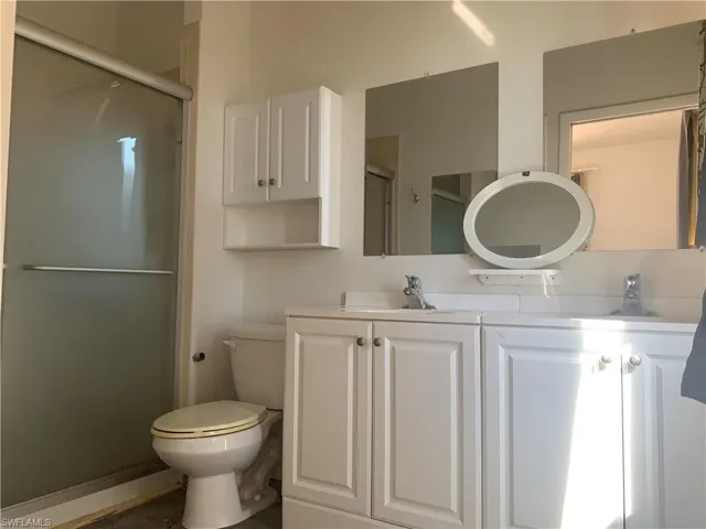 Guest Apartment Full bathroom with a shower stall, toilet, and vanity