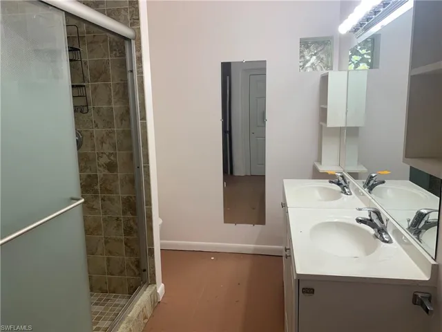 Full bathroom with a stall shower and a sink