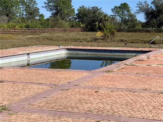 View of pool featuring fence