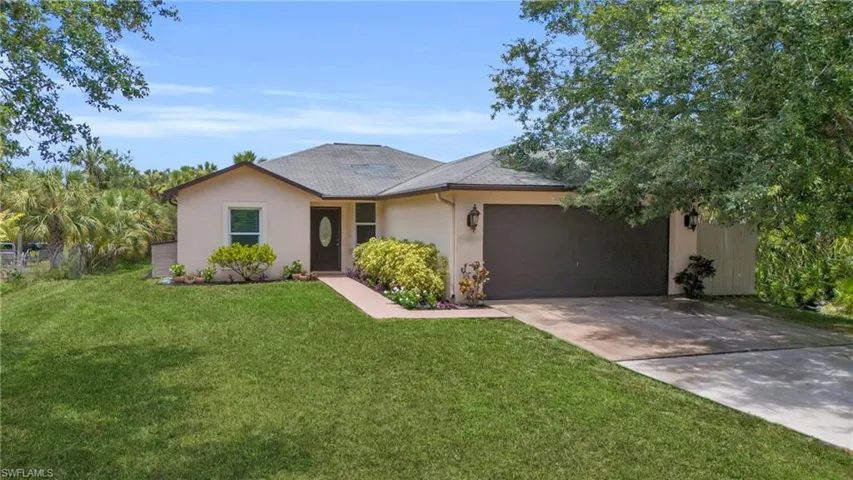 Ranch-style home with a garage and a front yard