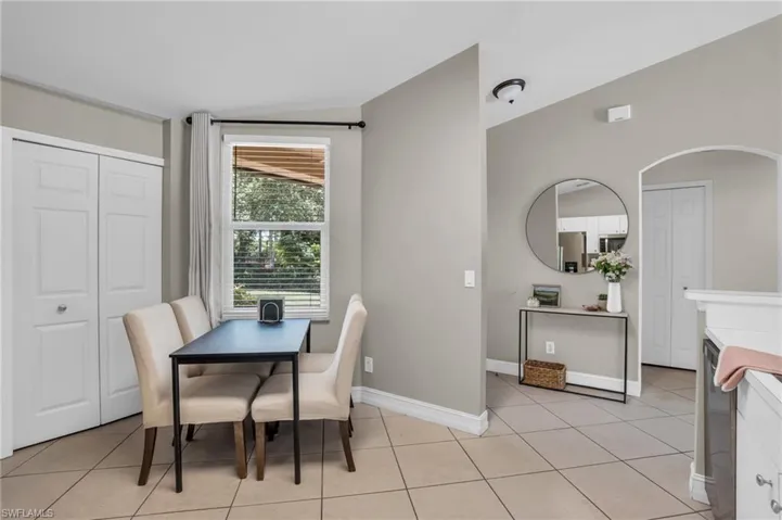 Dining area with light tile floors and lofted ceiling