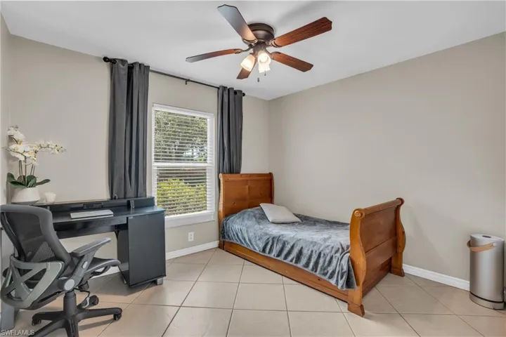 Tiled bedroom with ceiling fan
