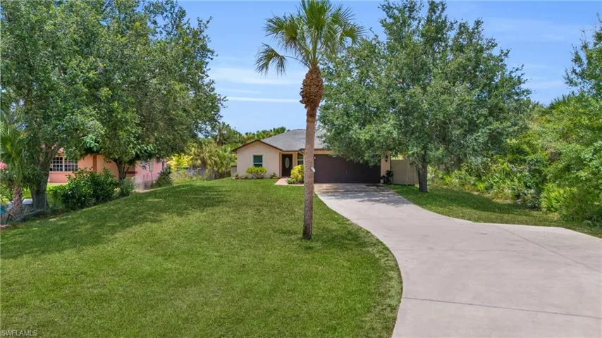 View of front of home featuring a garage and a front yard