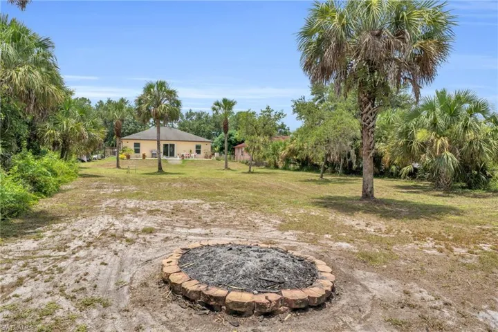 View of yard featuring an outdoor fire pit