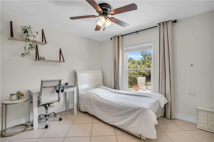 Tiled bedroom with ceiling fan