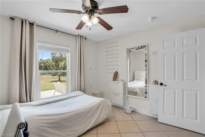 Tiled bedroom with ceiling fan