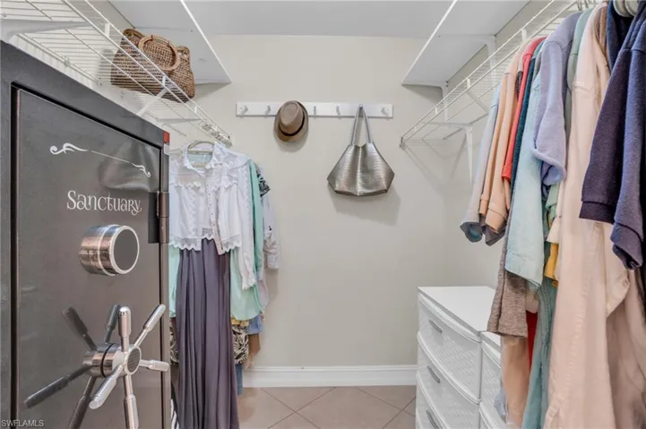 Walk in closet with tile floors