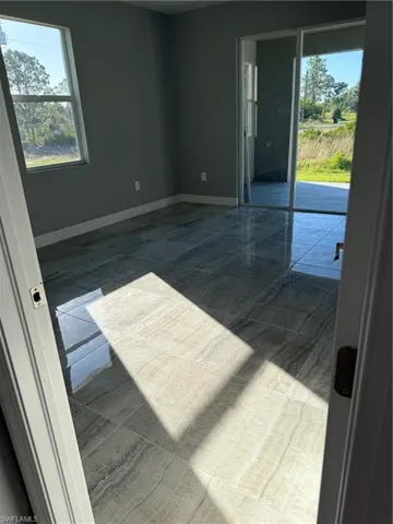Empty room featuring baseboards