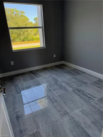 Spare room featuring baseboards