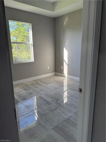 Spare room featuring baseboards