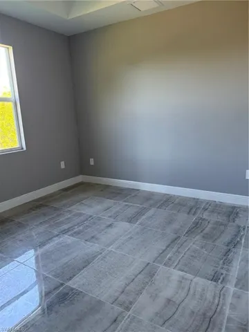 Empty room featuring baseboards