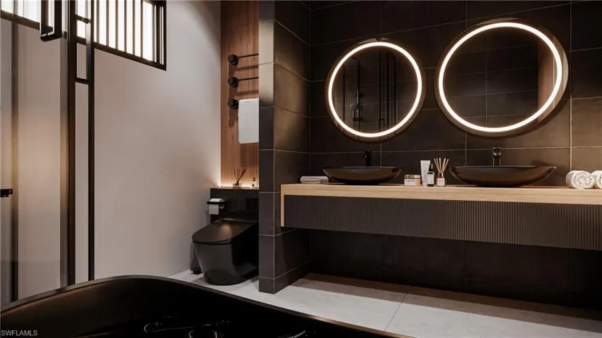 Bathroom featuring double vanity and toilet