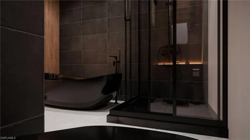 Full bathroom featuring tile walls, a freestanding bath, a stall shower, and tile patterned floors