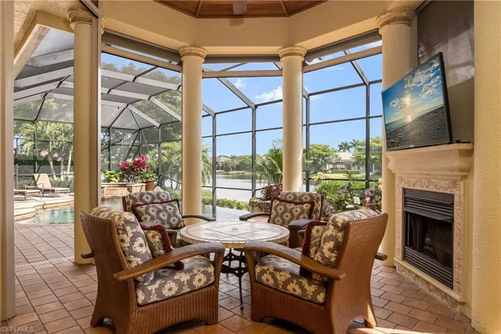 Relaxing in front of natural gas fireplace with fabric hurricane screen down in back of TV. Pecky cypress wood ceiling.