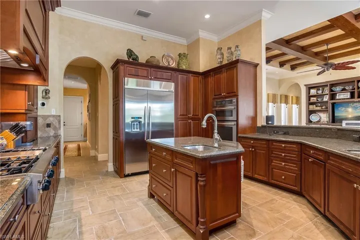 Granite countertops, stainless steel top of the line Kitchen Aid appliances, natural gas cooktop, center island water equipped