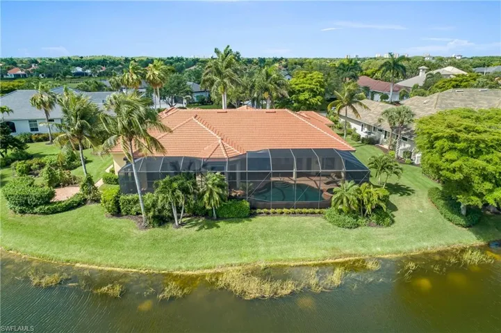 View of half acre oversized, premium lot and house from across the water. Private, quiet and serene.