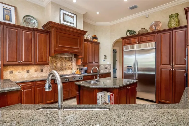 Two meal preparation areas with available water, 42" custom cabinetry, cooktop exhaust hood vents to outside