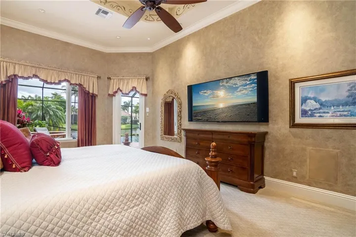 Bay window view to lanai and water, wall mounted TV conveys