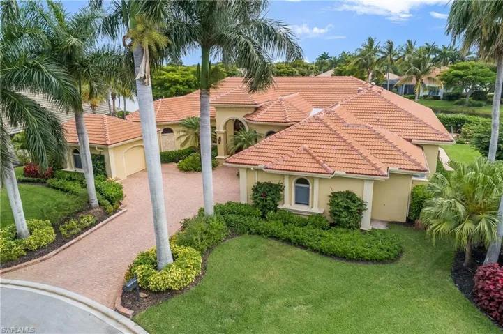 Aerial view of house and front lot...note the Royal Palms at driveway entrance. Windows and doors are Andersen 'hurricane proof' impact glass. Whole house 20KW Generac natural gas generator in case of power failure.