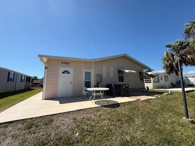 Rear view of property with central AC, a yard, and a patio area