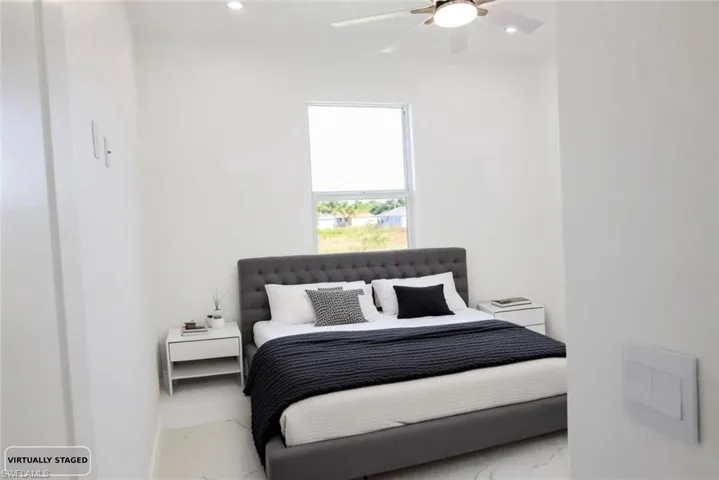 Bedroom featuring marble finish flooring, recessed lighting, and a ceiling fan