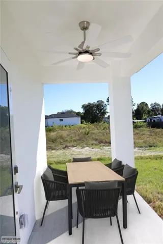 View of patio with a ceiling fan and outdoor dining area