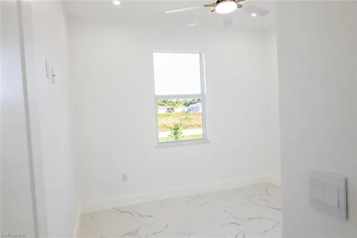 Unfurnished room with recessed lighting, light marble finish flooring, and a ceiling fan