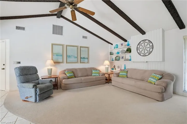 Spacious Family Room with High Cathedral Ceiling and Built-in Shelves