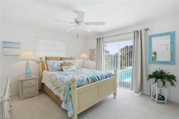 Guest Bedroom with sliders opening up to the pool deck.