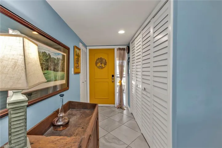 Doorway to outside featuring recessed lighting and light tile patterned flooring
