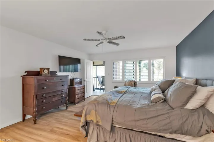 Bedroom with baseboards, a ceiling fan, and light wood-style floors