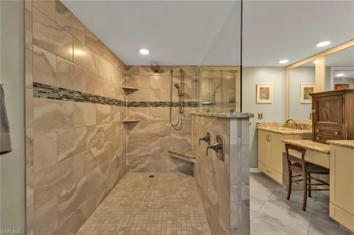 Full bath featuring recessed lighting, marble finish floor, vanity, and a walk in shower