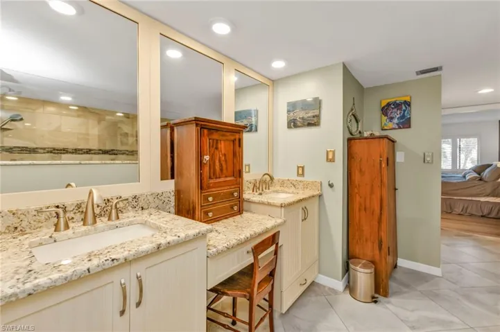 Ensuite bathroom with recessed lighting, visible vents, vanity, ensuite bath, and baseboards