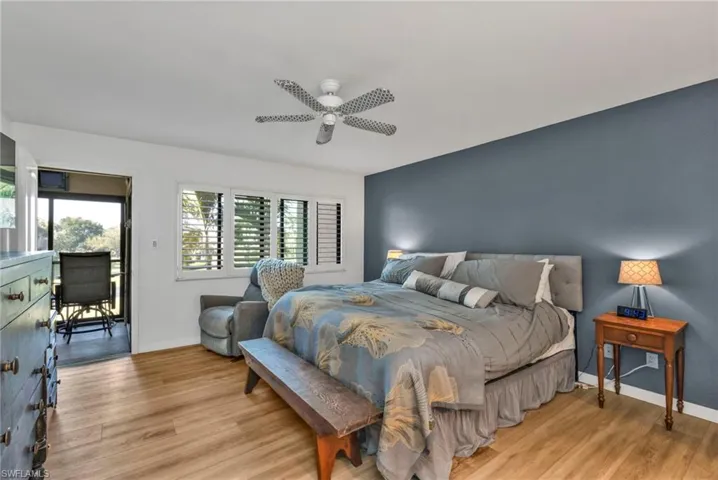Bedroom featuring light wood finished floors, ceiling fan, and baseboards