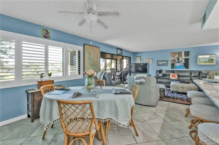 Dining area with light tile patterned floors, ceiling fan, a textured ceiling, and a wealth of natural light