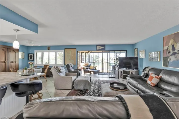 Living area with a textured ceiling and light tile patterned floors
