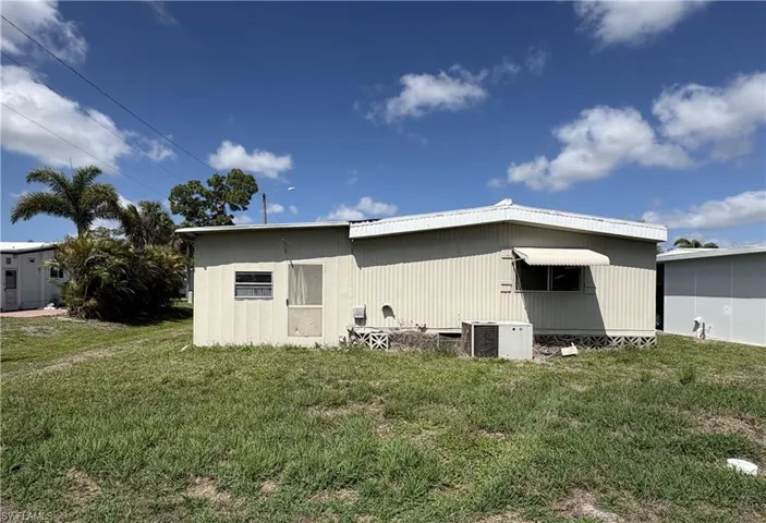 Back of property with a yard