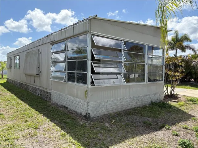 View of property exterior featuring a yard