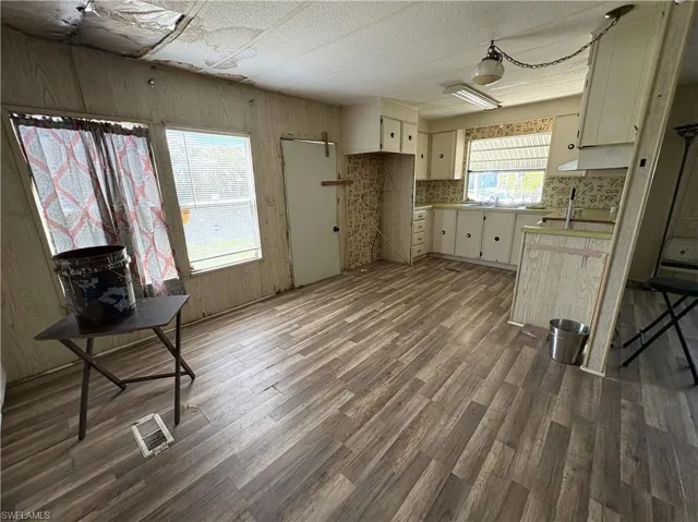 Kitchen with dark wood-style flooring and light countertops