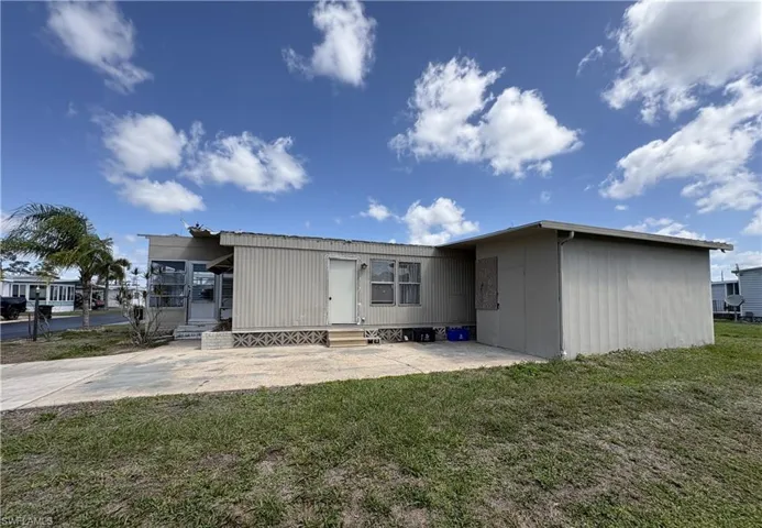 Back of property with a patio area, entry steps, and a yard
