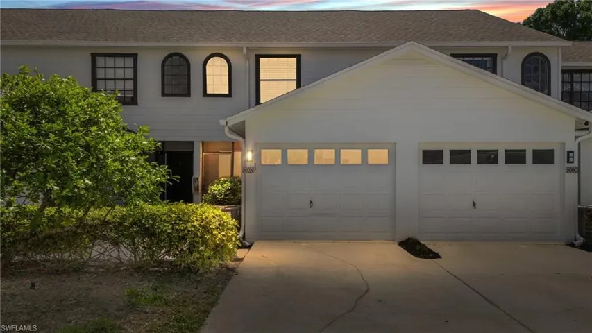 View of front of property with driveway, an attached garage, and roof with shingles