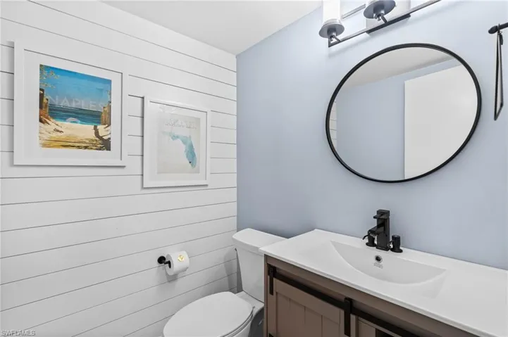 Half bathroom with vanity and toilet