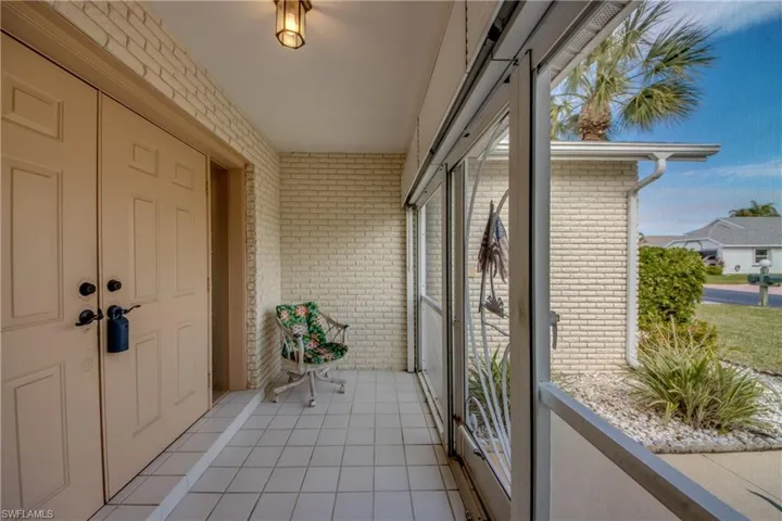 Tiled Front Porch with Double Door Entry + Hurricane Shutter.
